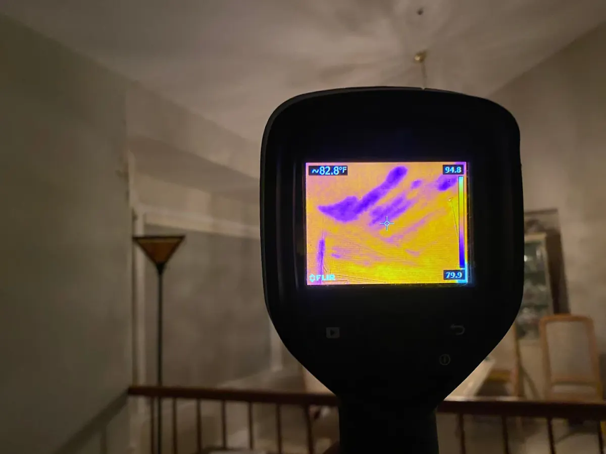 Thermal imaging camera detecting hidden moisture during water damage insurance inspection